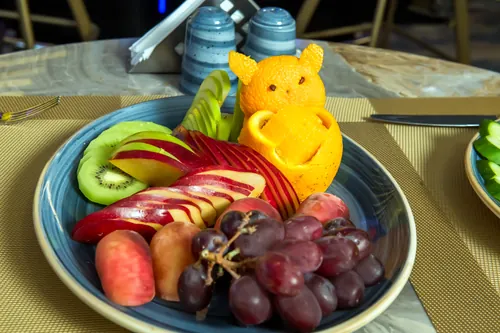 A fruit plate decorated with carved citrus