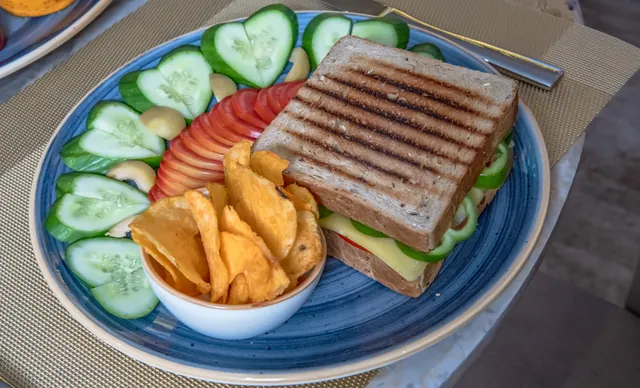 A club sandwich with fresh vegetables